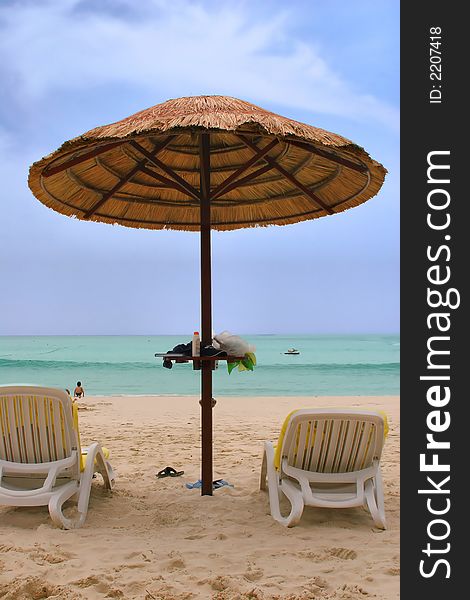 Sunchairs and umbrellas on beach in Phuket. Sunchairs and umbrellas on beach in Phuket