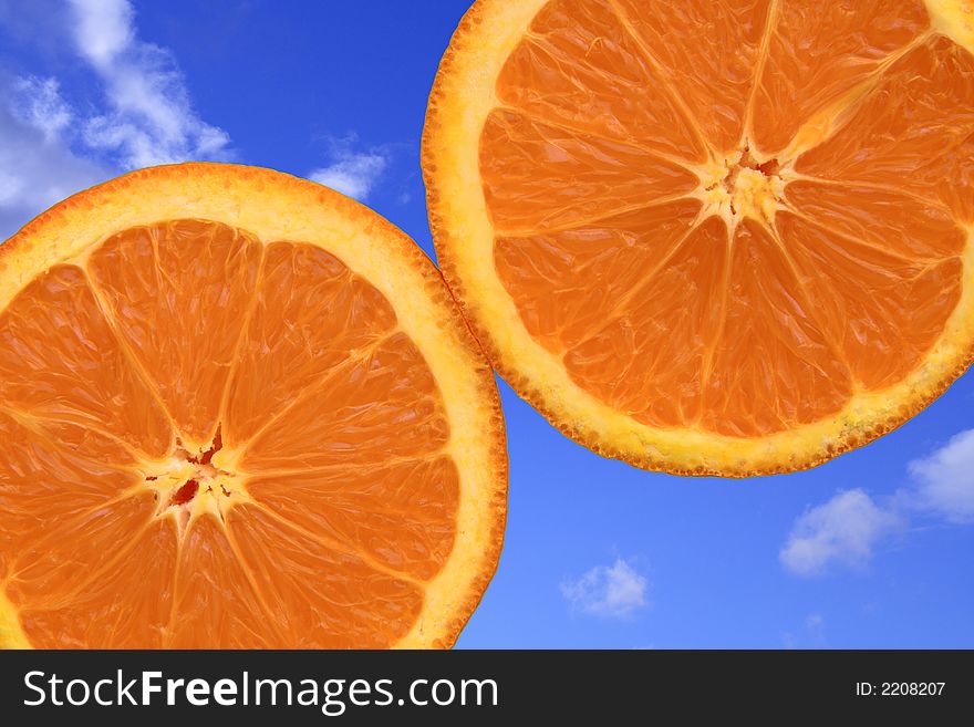 Close-up of oranges on blue sky