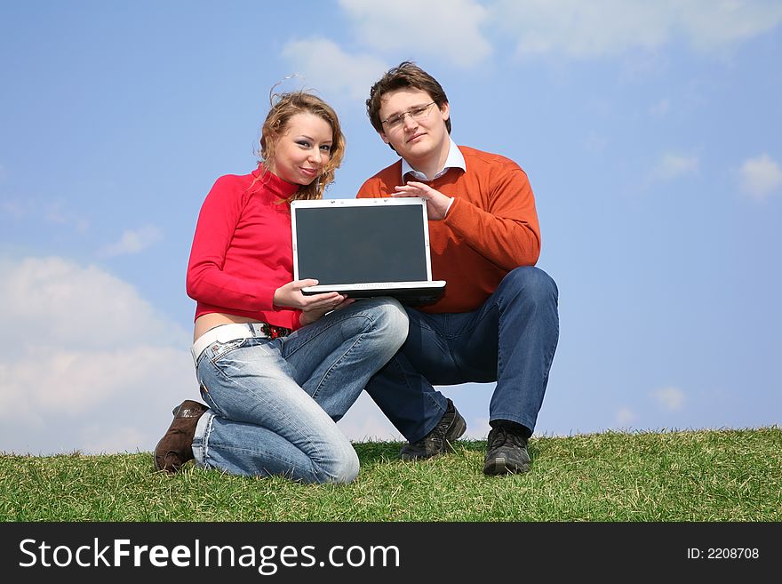 Couple with notebook on meadow