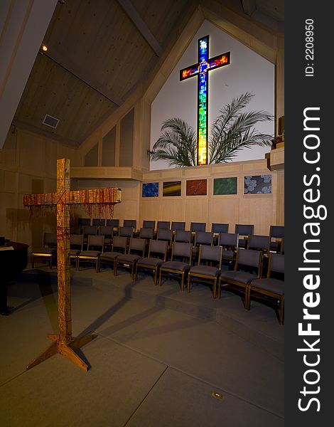 Shot of a stained glass cross in a Christian Church decorated for Easter.