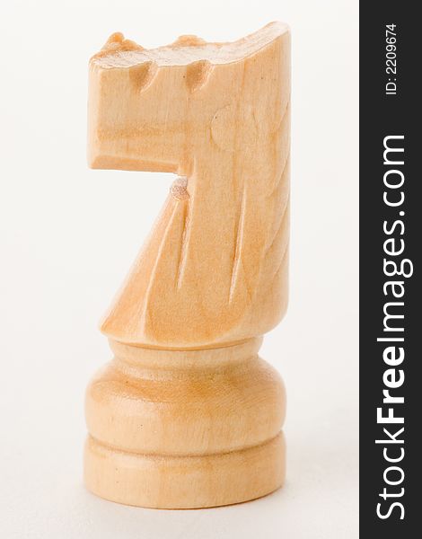 Wooden knight chess piece on white