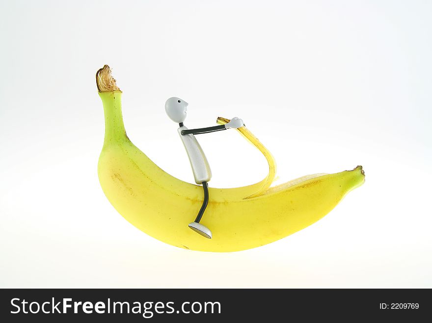 Figure pelling banana on white background. Figure pelling banana on white background