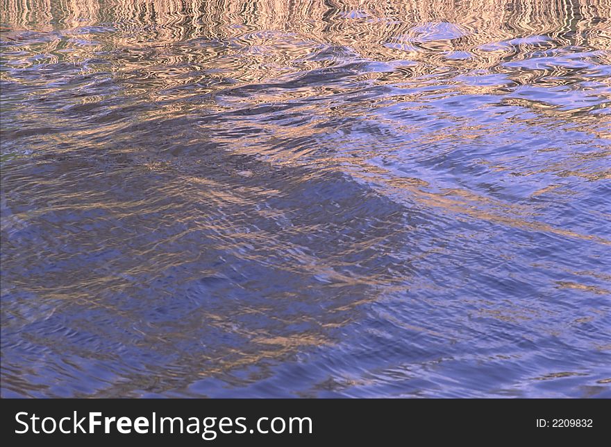 Reflection of heavenly, blue light in waves on  surface of water. Reflection of heavenly, blue light in waves on  surface of water