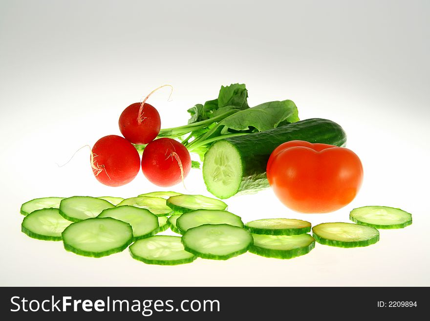 Green Cucumber and red radish and red tomato on white background. Green Cucumber and red radish and red tomato on white background