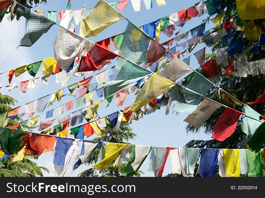 Buddhist prayer flags are hung in a holy place