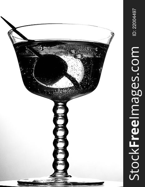Sparkling drink with cocktail cherry, black and white. Sparkling drink with cocktail cherry, black and white