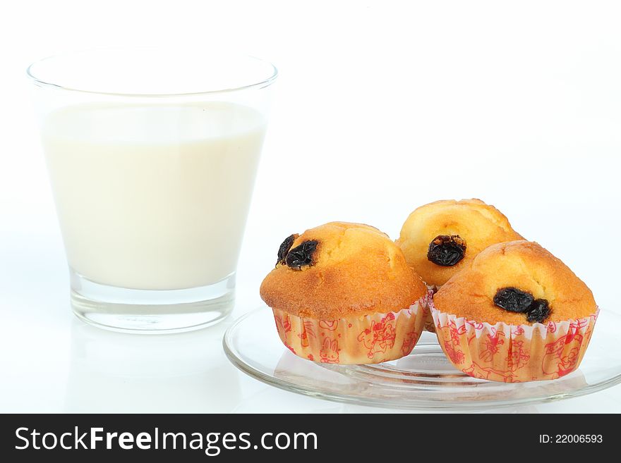 Muffin raisin and milk on white background