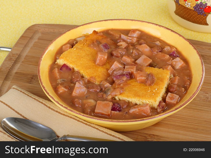 Ham and bean soup with corn bread in a bowl. Ham and bean soup with corn bread in a bowl