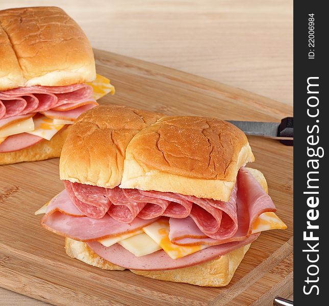 Lunch meat sandwiches on a cutting board