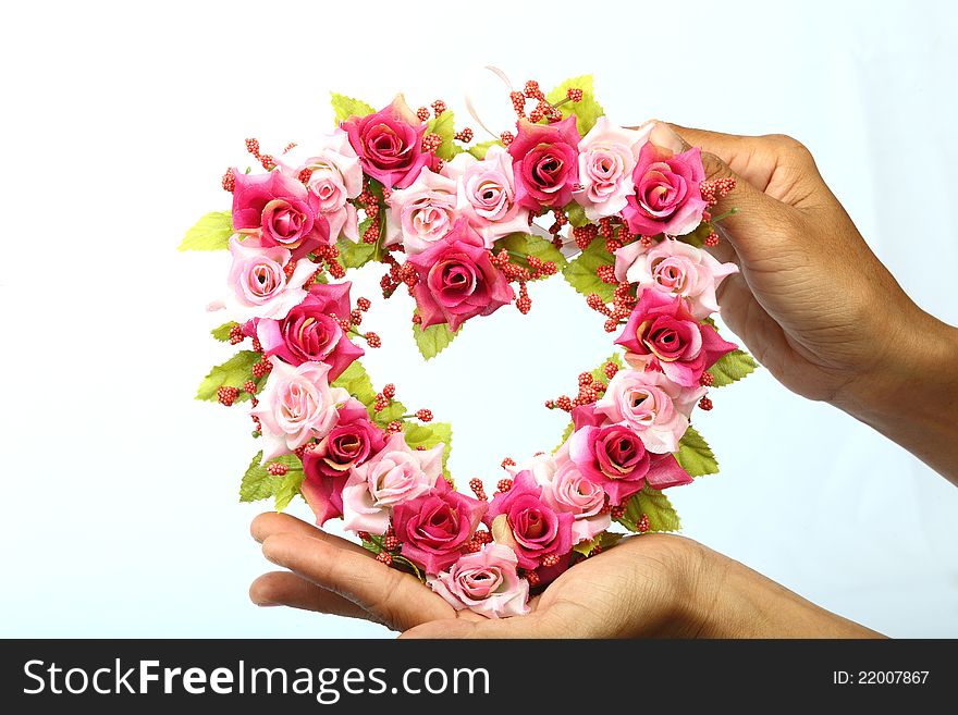 Heart rose invents of hand on white background