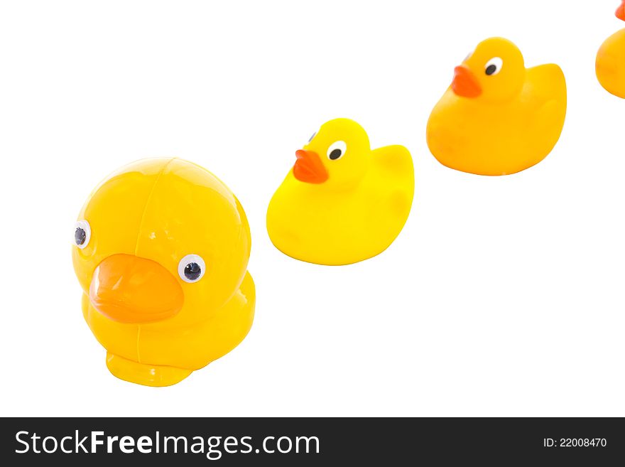 Family of yellow toy ducks isolated over white background. Family of yellow toy ducks isolated over white background