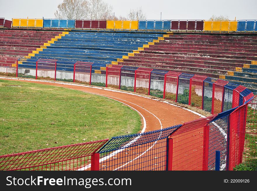 Red blue football stadium and metallic fence