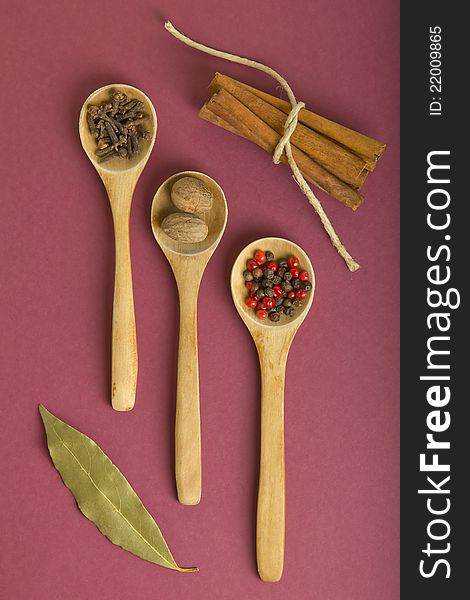 Wooden teaspoons with pepper, clove and nutmeg. Wooden teaspoons with pepper, clove and nutmeg.