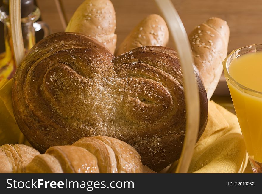 Sweet bread food in a basket over wood background