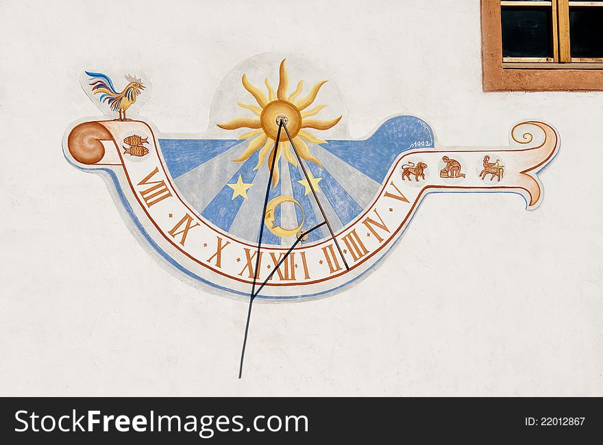 Colorful sundial painted on a white wall. Colorful sundial painted on a white wall