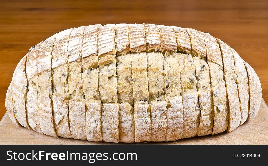 Close up of a loaf of pre-sliced olive and herb bread. Close up of a loaf of pre-sliced olive and herb bread.