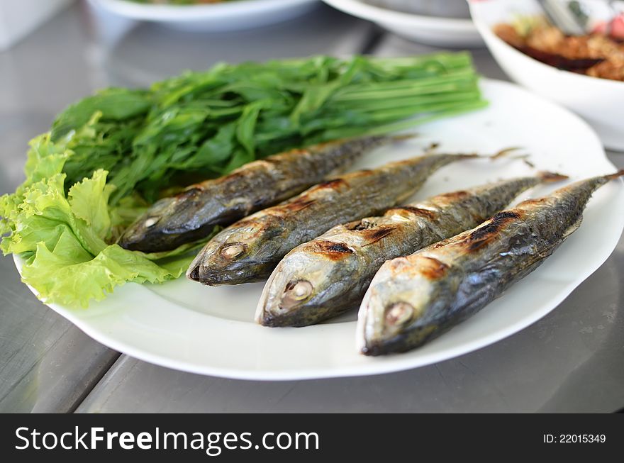 Fried sardine on plate in Asian restaurant in Asia