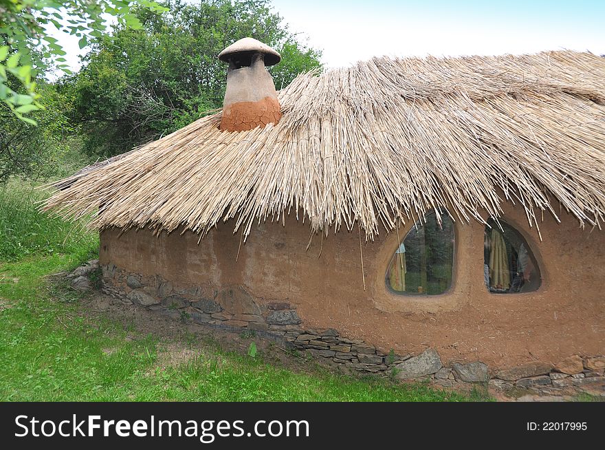 Old architecture house with roof of straw