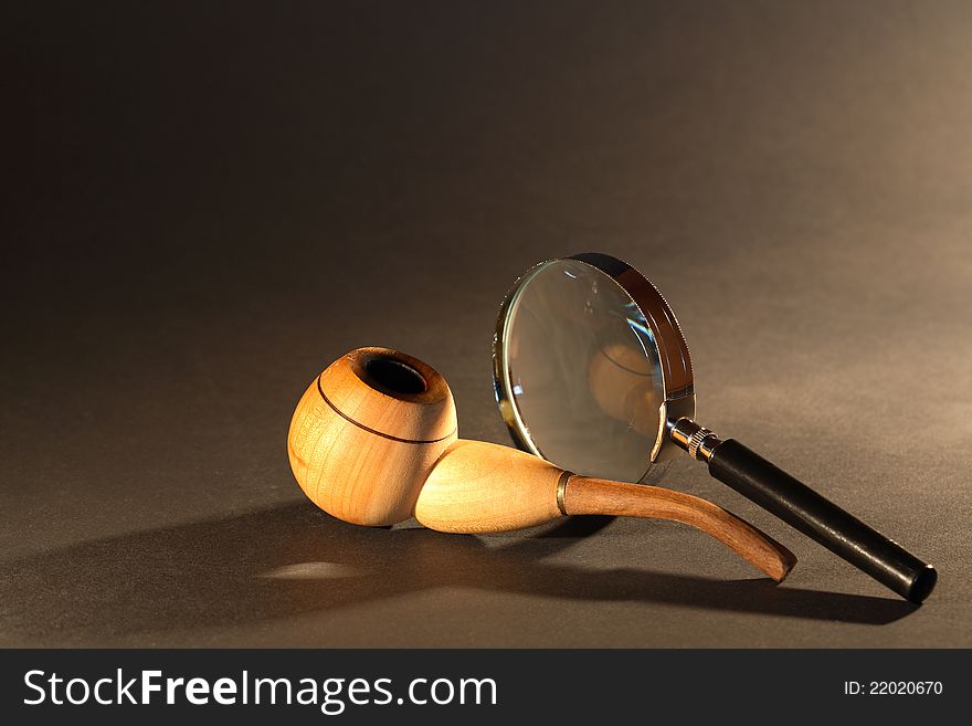 Magnifying Glass And Tobacco Pipe