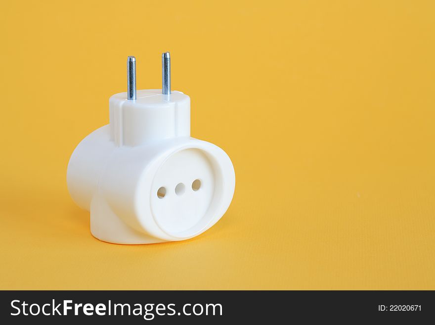 Pair of plastic socket outlet on yellow background with free space for text. Pair of plastic socket outlet on yellow background with free space for text