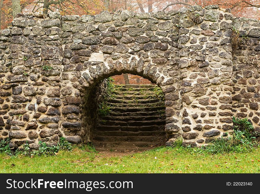 Medieval stone wall in autumn park