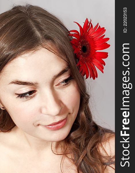 Portrait of young woman with flower in hair