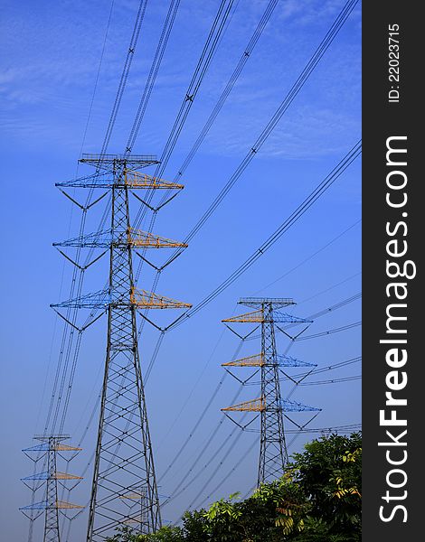 Power line on steel tower against blue sky