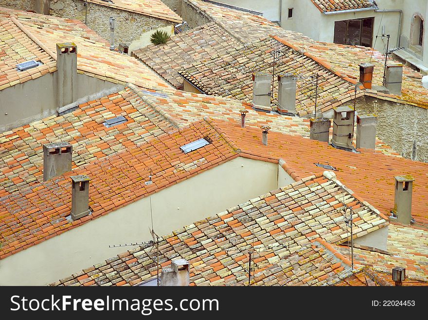 French roof tops covered with mixed colored terra cotta baked tiles. French roof tops covered with mixed colored terra cotta baked tiles