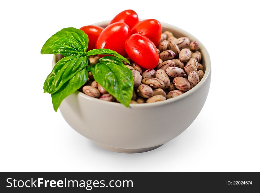 Beans, tomatoes and basil in a white cup