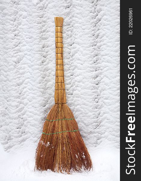 Handmade straw broom on the snow