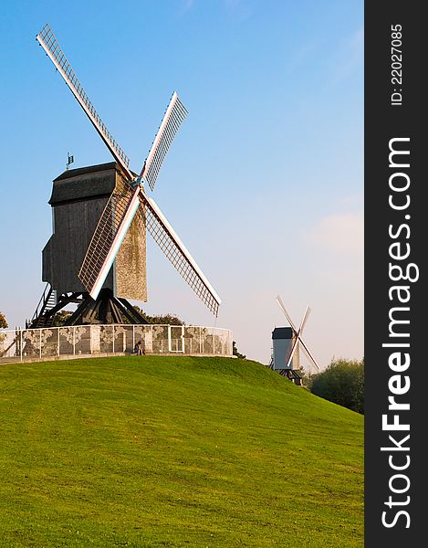 View of two old wind mill and green lawn at Brugge - Belgium. View of two old wind mill and green lawn at Brugge - Belgium