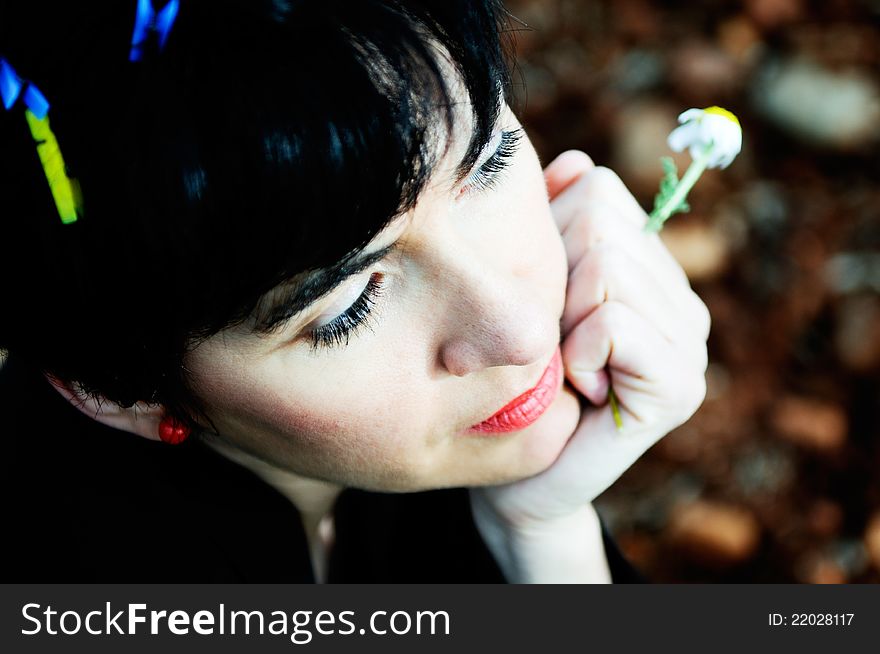 Portrait of a pretty brunette woman with clothespins on her hair thinking in the field. Portrait of a pretty brunette woman with clothespins on her hair thinking in the field