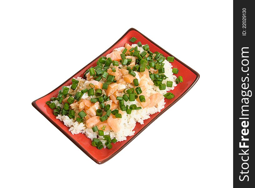 Delicious appetizing white boiled rice garnished with tasty sliced salmon and decorated with finely chopped green leek in rectangular black and red chinese dish isolated on white background. Delicious appetizing white boiled rice garnished with tasty sliced salmon and decorated with finely chopped green leek in rectangular black and red chinese dish isolated on white background