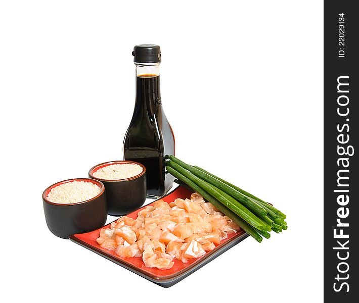 Appetizing sliced salmon in rectangulat dish, bottle of soya sauce, boiled rice in drinking bowl and green leek isolated on white background. Appetizing sliced salmon in rectangulat dish, bottle of soya sauce, boiled rice in drinking bowl and green leek isolated on white background