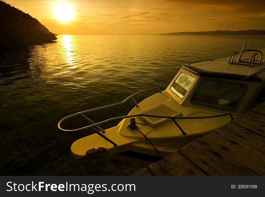 A common speedboat for diving and fishing, illuminated with sunset light. Picture taken from Raja Ampat island, papua, indonesia. A common speedboat for diving and fishing, illuminated with sunset light. Picture taken from Raja Ampat island, papua, indonesia.