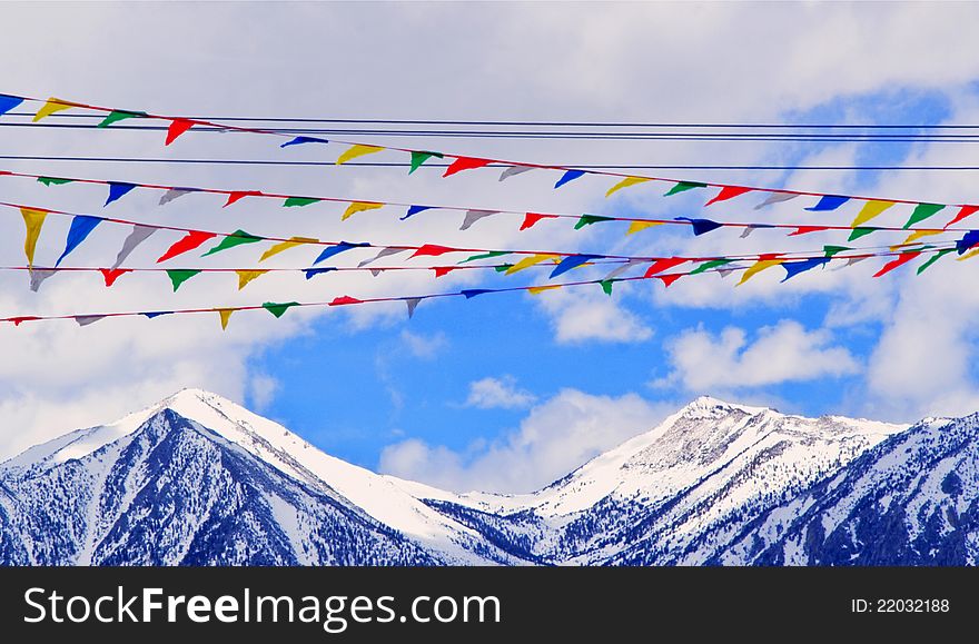 Landscape with mountains in snow,blue sky and colorful flags. Landscape with mountains in snow,blue sky and colorful flags