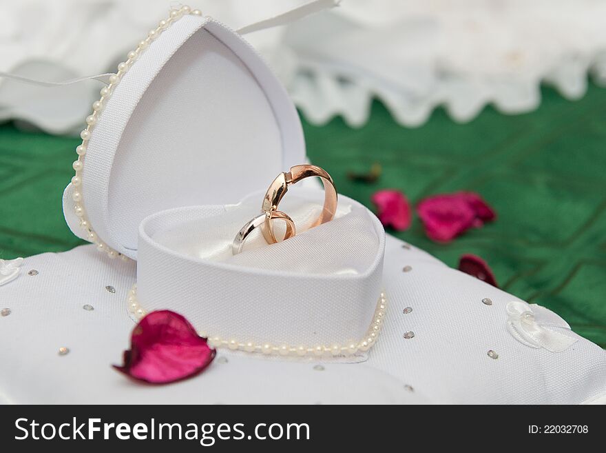 Golden wedding rings in a white box