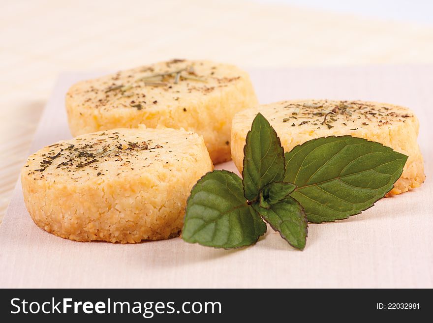 Freshly baked Parmesan cheese biscuits with black pepper, mint and rosemary. Freshly baked Parmesan cheese biscuits with black pepper, mint and rosemary.