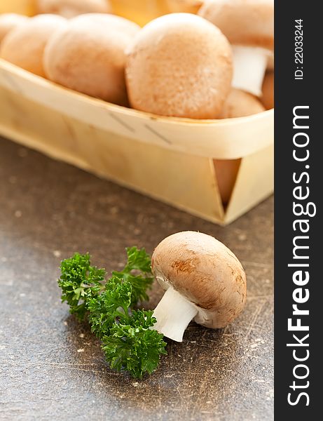 Fresh mushrooms in a basket with parsley