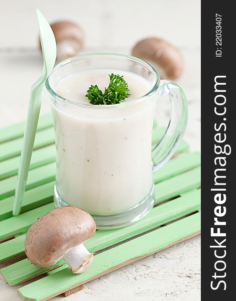Fresh mushroom soup in a cup with parsley
