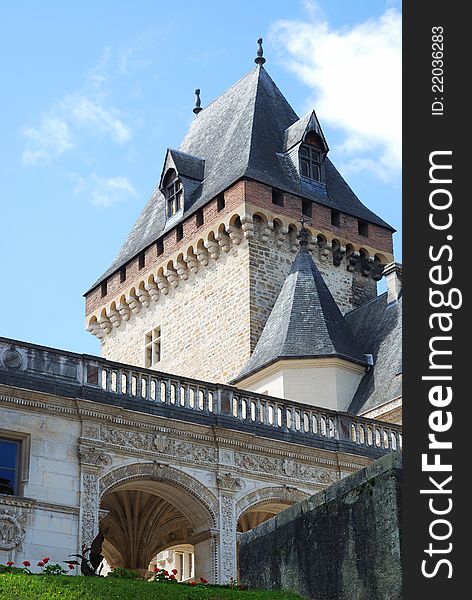 Medieval chateau is photographed from below against the blue sky. Medieval chateau is photographed from below against the blue sky.