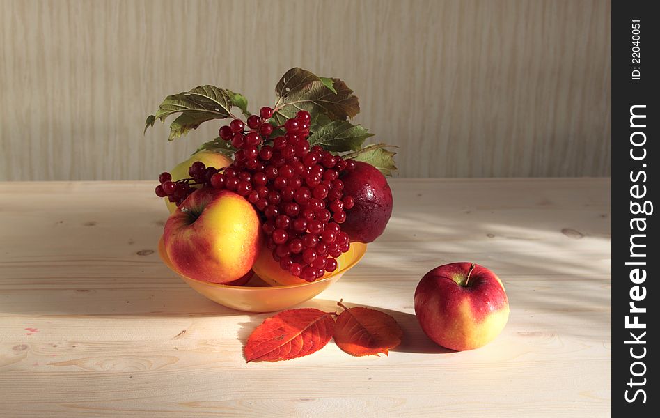 Apples and cranberry high berries in a plate on desktop. Apples and cranberry high berries in a plate on desktop.