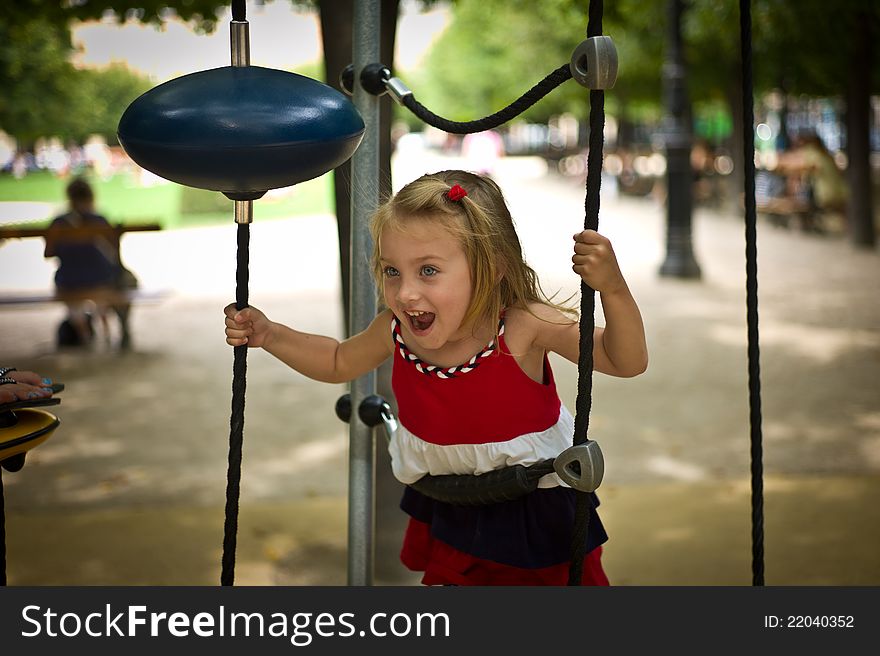 Young Girl Swinging in a Park. Young Girl Swinging in a Park