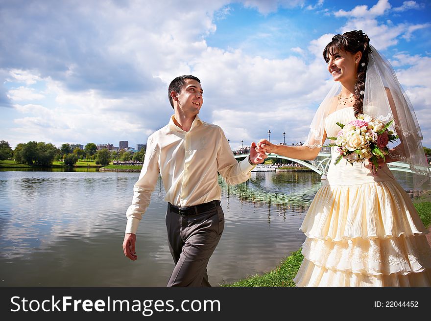 Happy Bride and groom at wedding walk in park