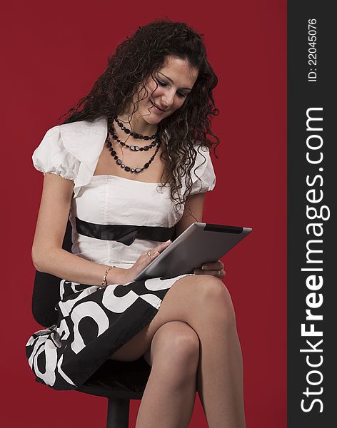 Tablet pc and young businesswoman in studio, isolated on red. Tablet pc and young businesswoman in studio, isolated on red