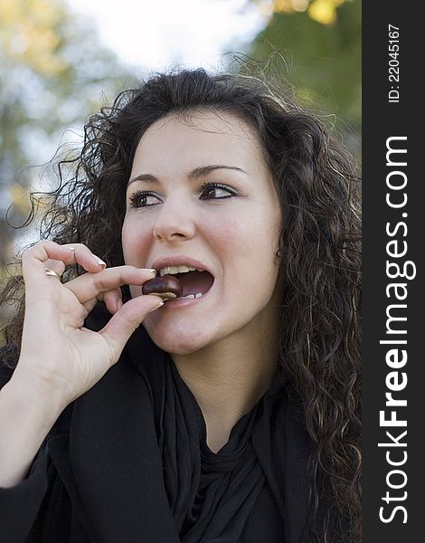 Close up of young  woman with wild chestnut. Close up of young  woman with wild chestnut