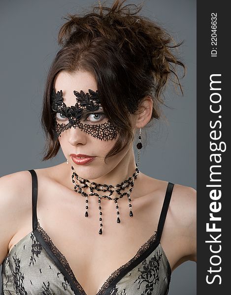 Portrait of an attractive young woman in elegant lace mask and accessories. Portrait of an attractive young woman in elegant lace mask and accessories