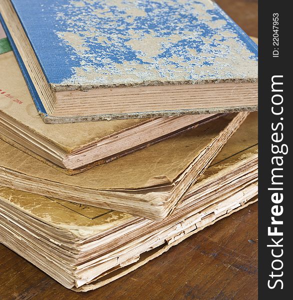 Stack of old books on wooden table