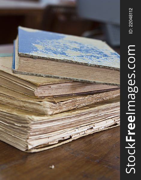 Stack of old books on wooden table