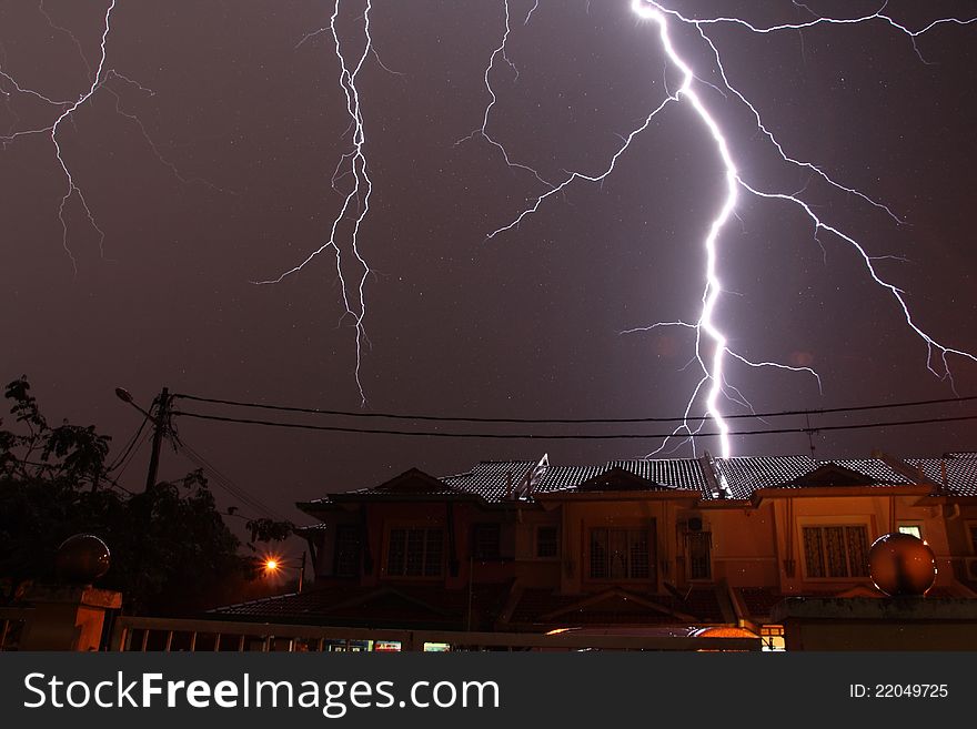 Lightnings over a residential during a thunderstorm at night. Lightnings over a residential during a thunderstorm at night